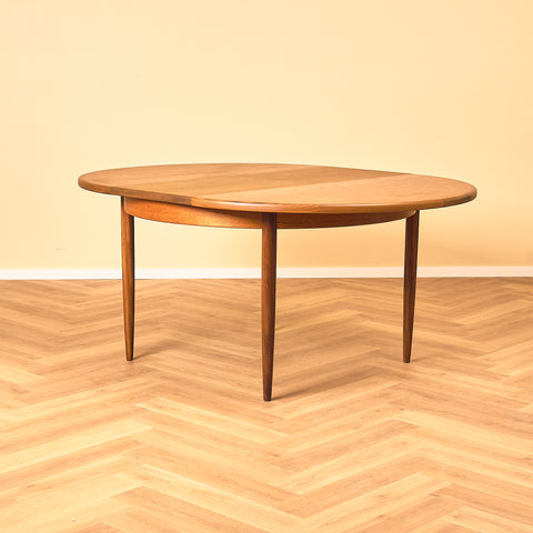 British round dining table in walnut and teak by G-Plan