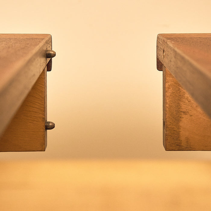 Round Teak Extendable Dining Table, close-up of the leaf alignment pins